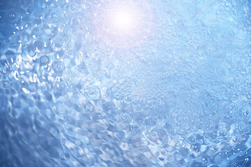 Bubbles and seething water in the light of sunlight.Blue water texture.