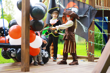 Children's party in a pirate style. Children in pirate costumes are playing on Halloween.
