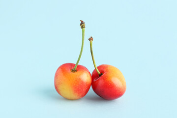 Sweet yellow cherries on blue background