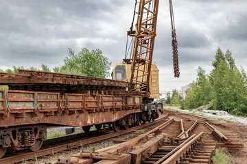 Mobile railway crane on a platform. Replacement and repair of railroad sleepers and other elements. Repair and reconstruction of the railway.
