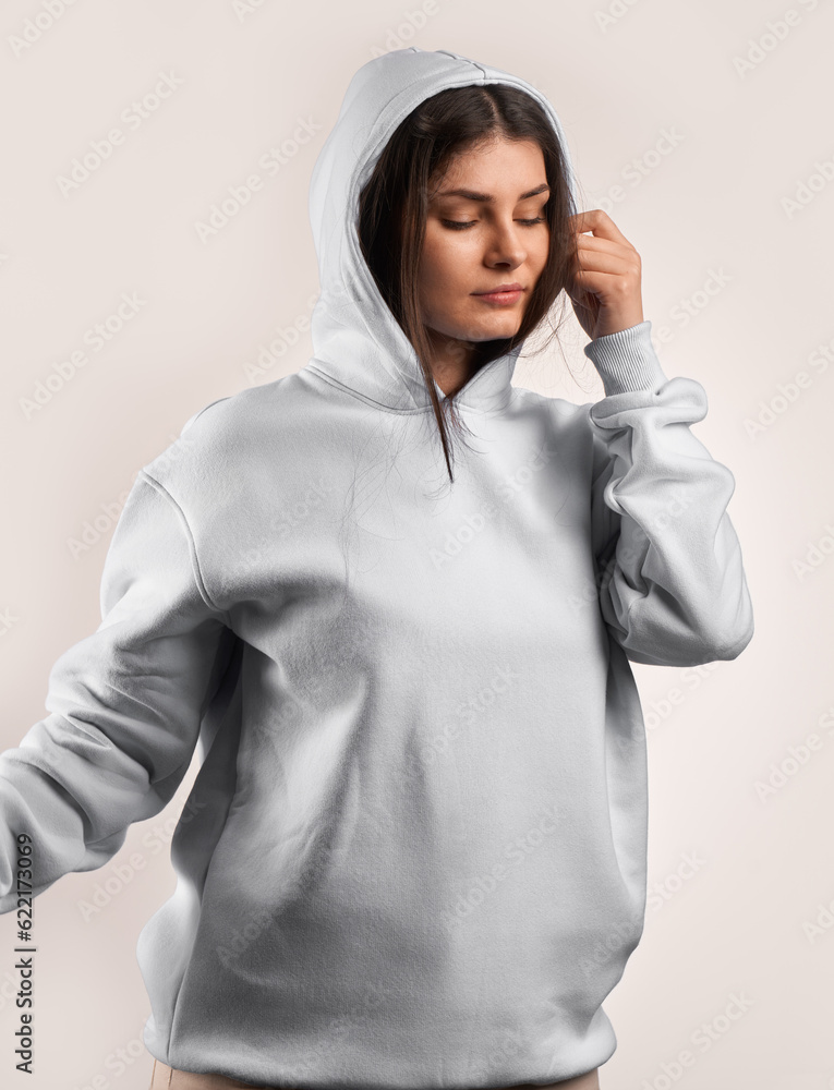 Canvas Prints Woman Showcasing a white Hoodie for Logo Branding. Streetwear clothing mock-up. Logo on shirt template copy space.