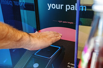 Male hand scanning his palm to pay with modern wireless payment technology