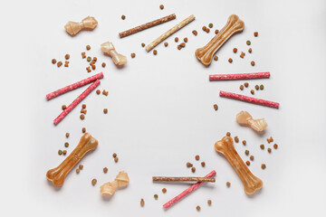 Frame made of different dog food on light background