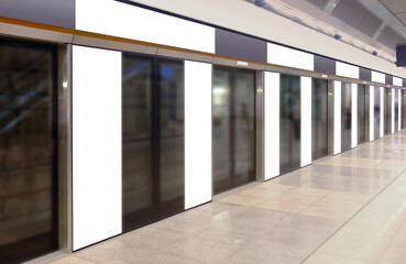 Perspective view of mockup of multiple blank banners, posters, in generic train station; advertising space templates; OOH mock up. Straight front view of MRT platform, without people