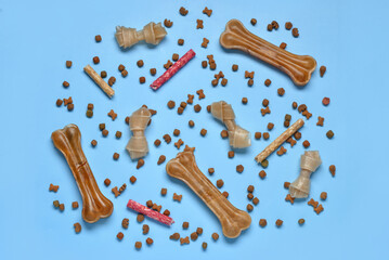 Composition with different dog treats on blue background