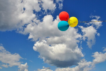 Multicolored helium filled balloons in the sky.