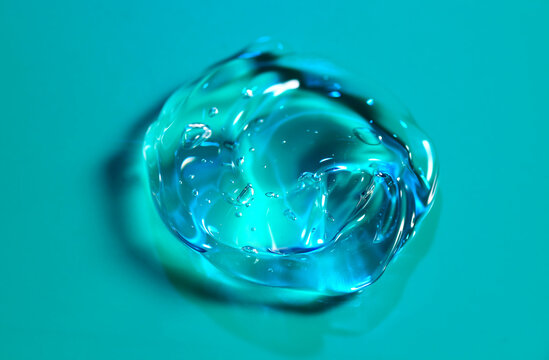 Transparent gel drop. Liquid cream gel cosmetic smudge texture on blue or green background. Cosmetics product, serum gel, thick hyaluronic acid, cream smear, skin care facial treatment, fluid