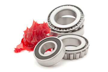 Tapered roller bearings with red lithium grease (Machinery Lubrication). Isolated on white...