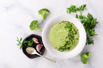 Broccoli green soup with fresh parsley. Healthy and diet vegan dish. Top view on stone table.