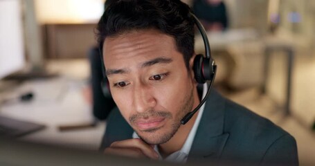 Call center, listen and man with a headset for customer service, advice or crm. Face of asian person working late at office for telecom, telemarketing or technical support at help desk with attention