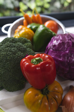 Close up of colourful vegetables on white worktop in kitchen