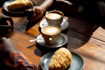 Hands of african american couple sitting at table in a cafe