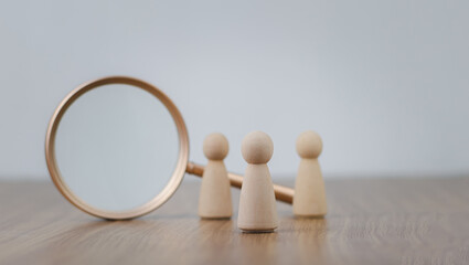 Human Resource Management Network Structure (HRM), wooden human figure stands near a magnifying...