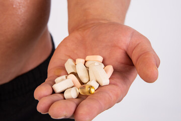 Young attractive sportsman with food supplements.