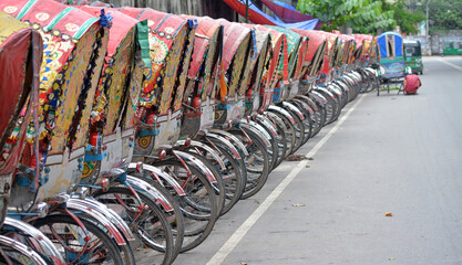 Rickshaws are also popular transport  and a vehicles in whole over Bangladesh. Hundreds of rickshaws parked in the capital city of Dhaka in Bangladesh.
