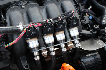 Close up car engine gas injection. lpg car injectors in car engine need to service, gas injector installed in gasoline engine to use cheaper alternative fuel.
