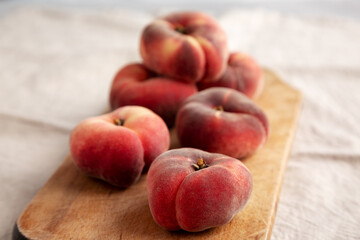 Organic Donut Saturn Peaches on a rustic wooden board, side view. Close-up.