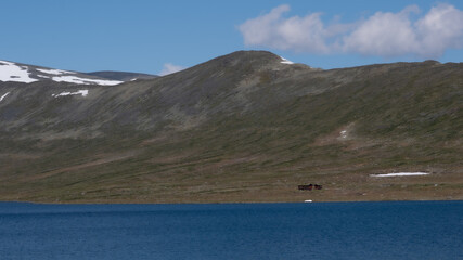 small cottage by the lake in the mountains