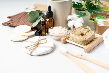 Fototapeta na wymiar Natural bathroom and home spa tools. Zero waste sustainable lifestyle concept. Bamboo toothbrush, natural shampoo, cotton pads, homemade DIY beauty products in reusable bottles on white background.