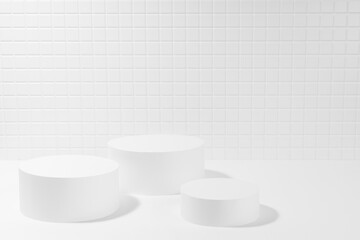 Elegant white abstract stage mockup with three cylinder podiums in hard light, shadow, template for presentation cosmetic products, spa, goods, tiny mosaic tile in simple minimal beauty style.