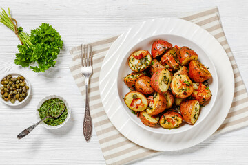 Herbs Garlic Potatoes in white bowl, top view