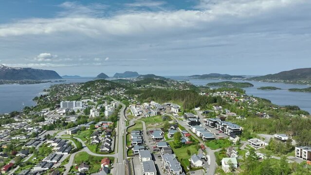 Spjelkavik, Hatlanda, Breivik and Moa residential area close to the Asefjord righ next to Alesund Norway - Summer aerial above island leading to Alesund