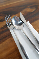 Table arrangement and setting on wooden table with stainless steel cutlery