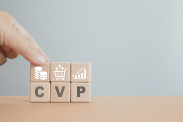 CVP text and graph on wooden cube blocks, cost, volume, profit   including copy space, Business and finance concept