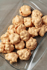 Crunchy homemade cookies on glass plate on gray background