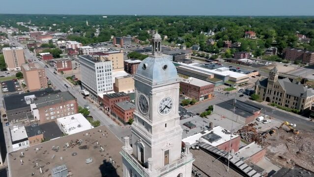 Clock tower in downtown Davenport, Iowa with drone video moving around in a circle.