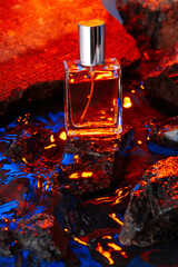 Bottle of perfume on a background of stones