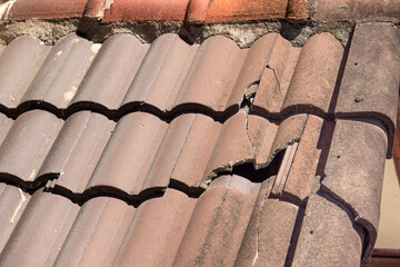 Damaged old roof tile in need of repair.