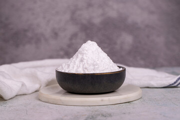 Wheat starch on stone background. Wheat starch in bowl. close up