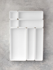 A set of plastic containers, boxes for convenient storage inside a drawer in the kitchen and at the desk.