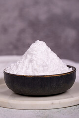 Wheat starch on stone background. Wheat starch in bowl. close up