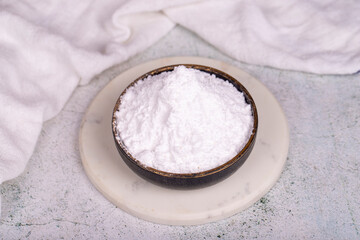 Wheat starch on stone background. Wheat starch in bowl. close up