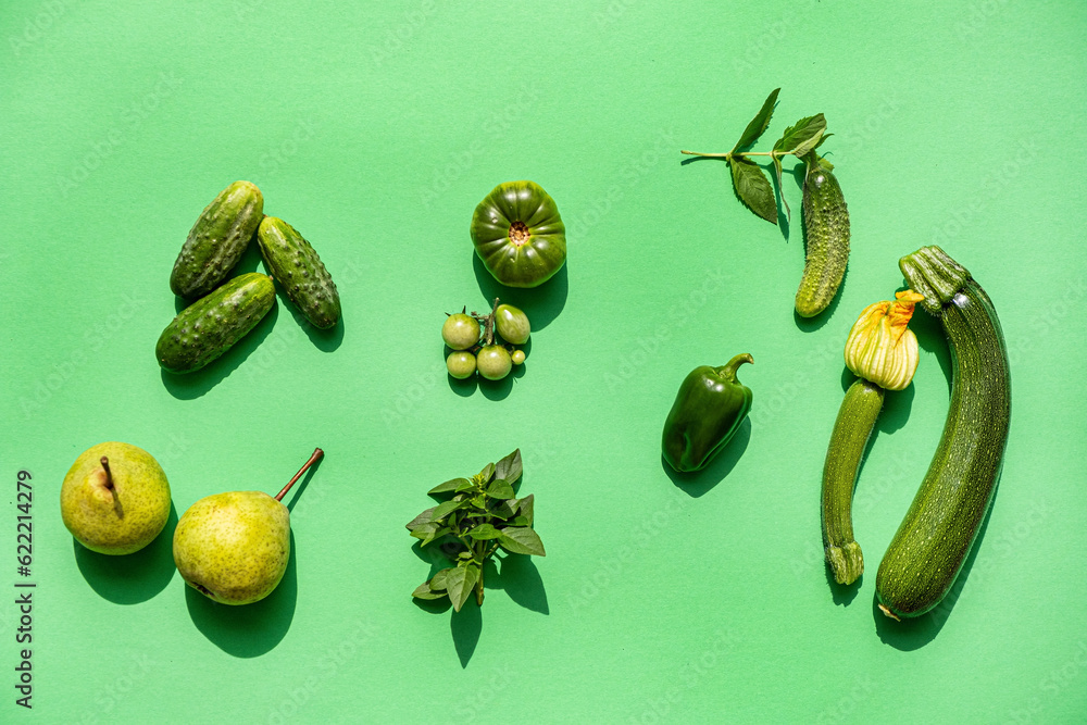 Wall mural green vegetables on the green background