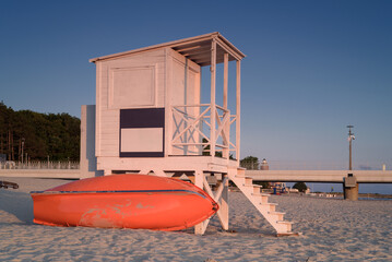 HOLIDAY RESORT - Lifeguards watchtower at morning on sea beach with pier and lighthouse at...