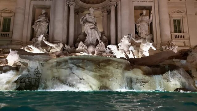 Incredible low angle view of Fontana di Trevi fountain in Rome at night with nocturnal illumination. Italy 