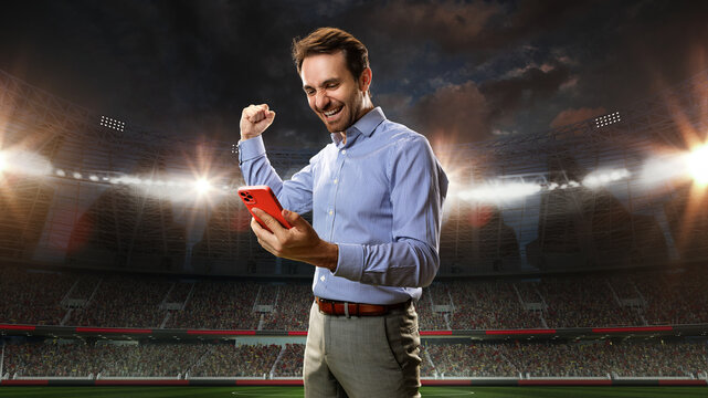 Positive, happy, emotional businessman holding mobile phone and celebrating money win. Sports betting. Luck. 3D arena background. Concept of sport, fan, betting and finances, gambling, bookmaker