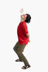 Indonesian men celebrate Indonesian independence day on 17 August with crackers eating competition