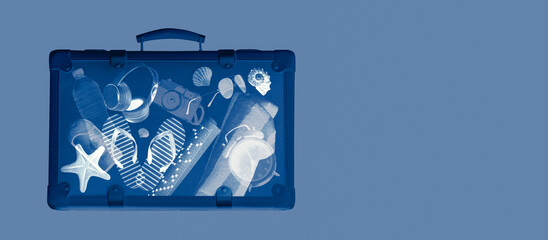 X-ray scan of a suitcase with travel and vacation accessories inside