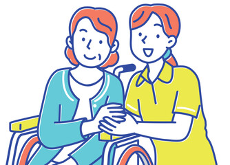 手を取り合う若い女性の介護士と車いすのシニア女性