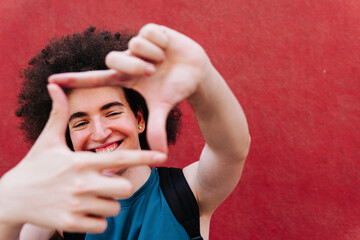Teen boy gesturing a frame with hands