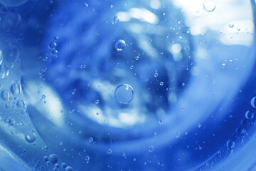 Oil bubbles close up. circles of water macro. abstract light blue background