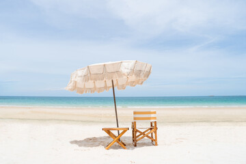 Beach umbrellas and chairs with white sand and perfect blue sky.