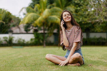 lifestyle woman phone tree happy grass blogger smiling nature palm park browsing