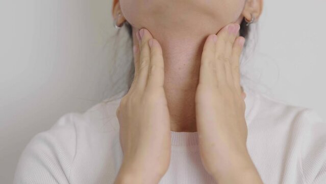 Woman checking Thyroid gland disease. Hand holding Neck pain. Hyperthyroidism, Hypothyroidism, Hashimoto Thyroiditis, Thyroid Tumor and Cancer, Postpartum, Papillary Carcinoma and Health concept