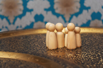 wooden figurines of people on the table. subject photo session of humanoid toys in the room. wooden...