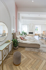 spacious open-plan apartment with stylish modern bright design, dressing area, bedroom, living room and bathroom on a sunny day